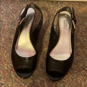 Open toed thick heeled black shoes.